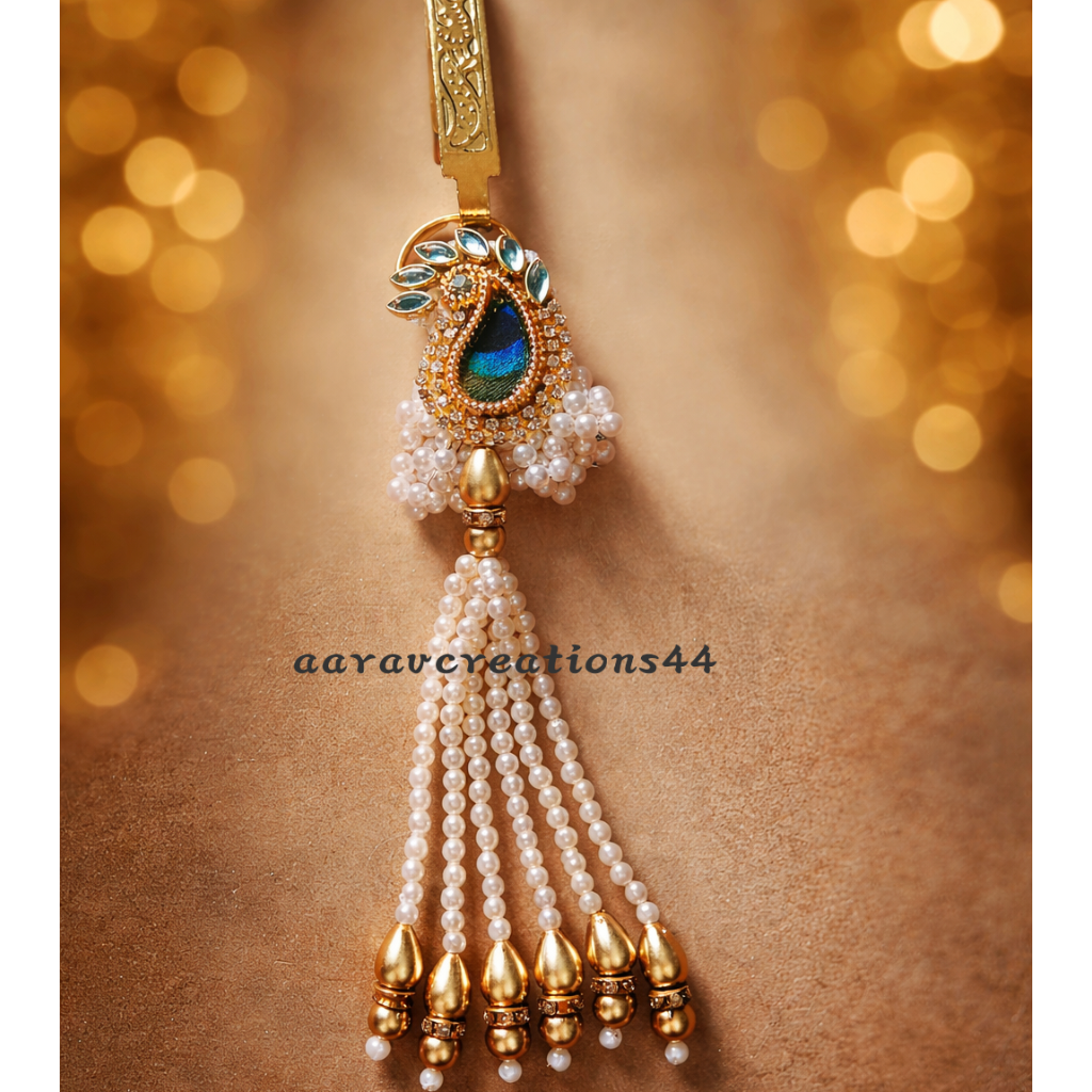 Decorative keychain with pearls and gold accents on a brown background