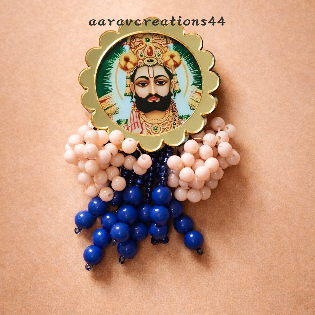 Decorative brooch with blue and white beads on a beige background