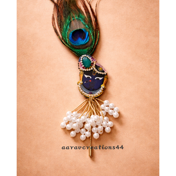 Decorative brooch with peacock feather, pearls, and gemstones on a beige background